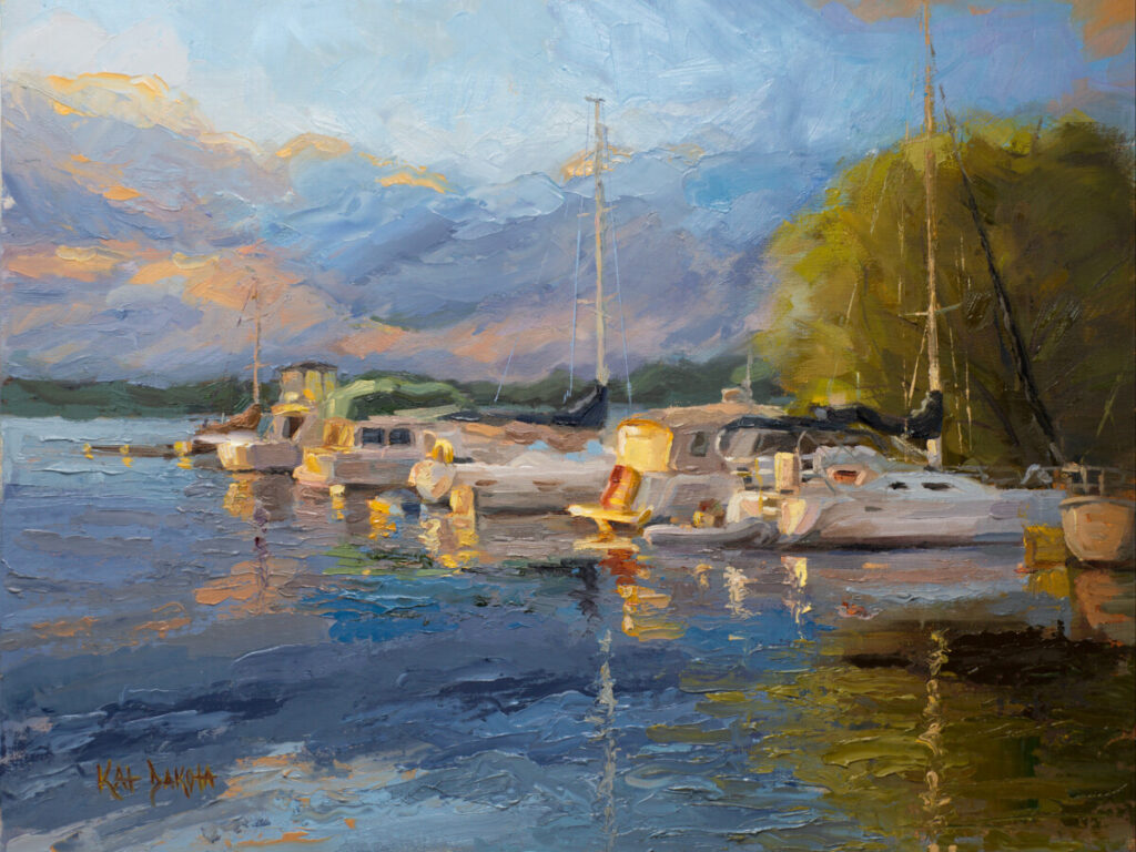 Sunrise illuminating sailboats in Suttons Bay, MI marina